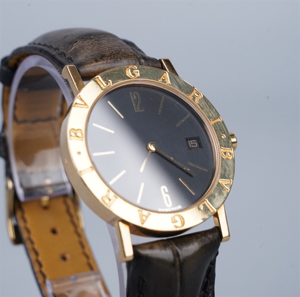 Đồng hồ Bvlgari mặt tròn viền vàng dây đen (95462) KG+