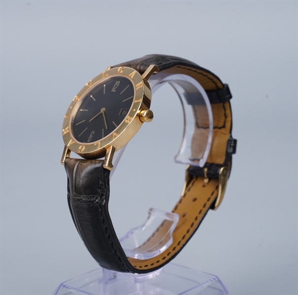 Đồng hồ Bvlgari mặt tròn viền vàng dây đen (95462) KG+